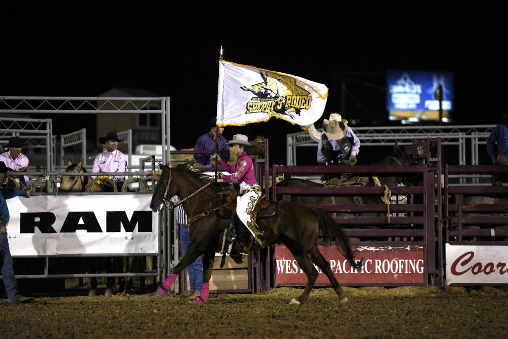 Sabrina Snowball, Miss San Bernardino Sheriff's PRCA Rodeo Queen 2015 proudly displaying her flag at the 2015 RAM PRCA California Circuit Finals Rodeo