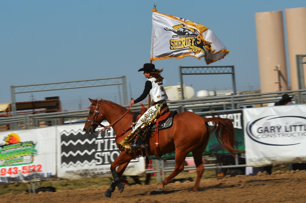 2014 San Bernardino Sheriff's PRCA Rodeo Queen, Sabrina Snowball presenting her rodeo's flag at the 2014 RAM PRCA California Circuit Finals Rodeo