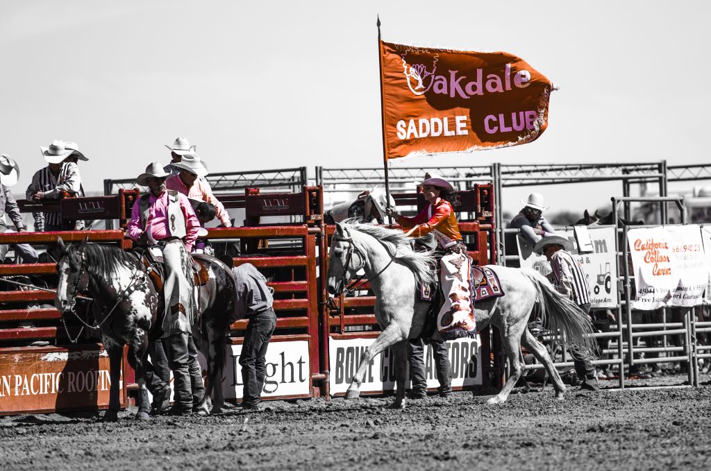 Miss Rodeo Oakdale 2016, Rachel Snitchler, presenting the Oakdale Saddle Club Rodeo Flag, at the 2016 RAM PRCA California Circuit Finals Rodeo